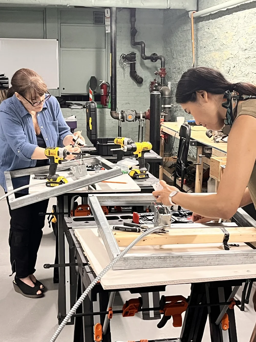 Two students working together at a Back to Basics workbench