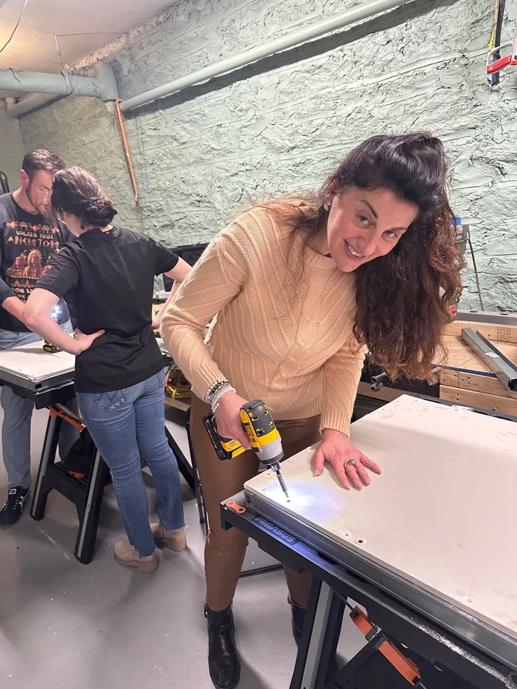A student leaning in to work on a project at the workshop